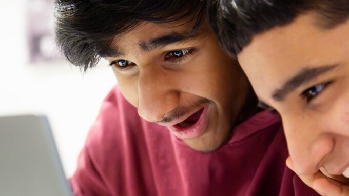 Kille i tonåren som tittar engagerat på sin skärm under en kursutbildning på Tekniska museet.